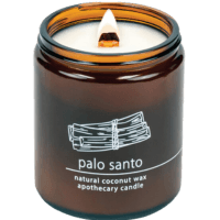 White wood wick palo santo infused candle in amber colored glass jar