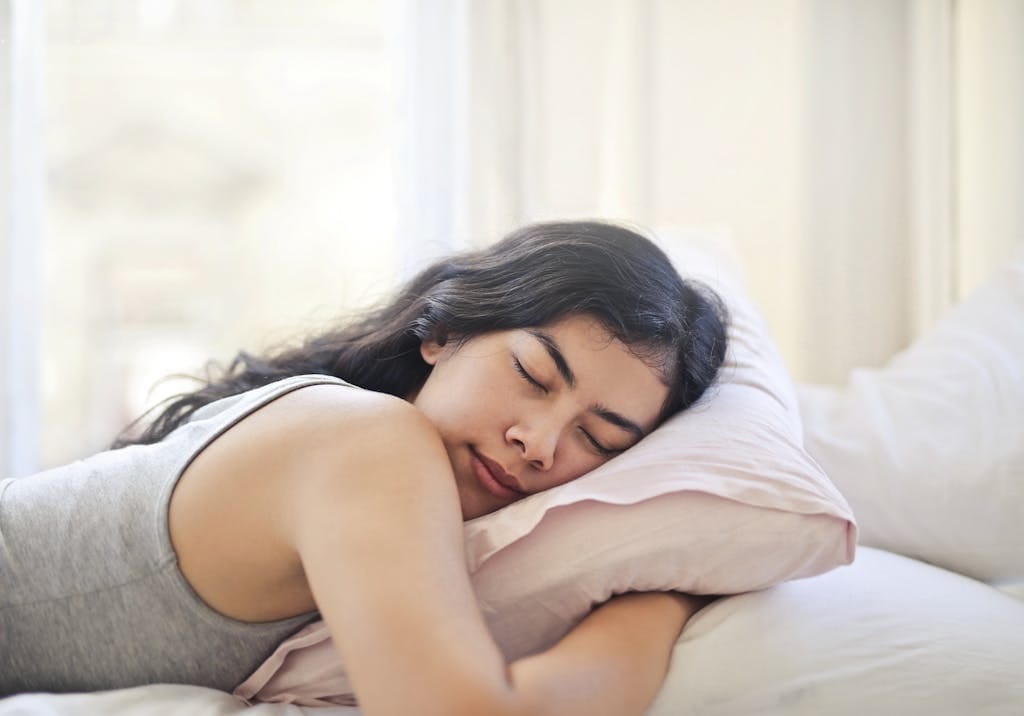 Woman in Gray Tank Top Lying on Bed sleeping