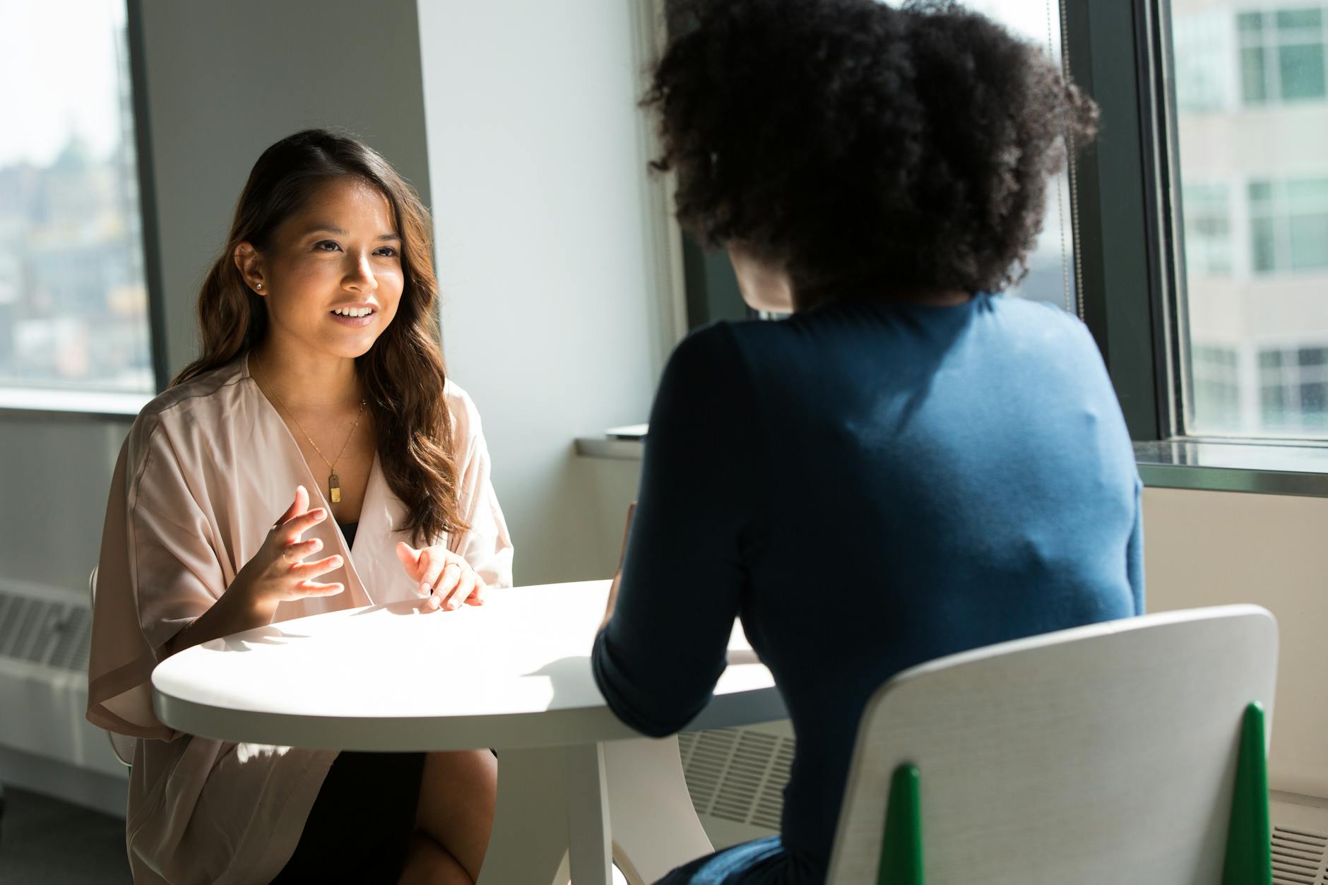 two women discussing financial wellness