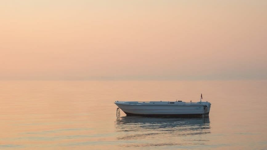 tranquil boat at sunset on calm sea