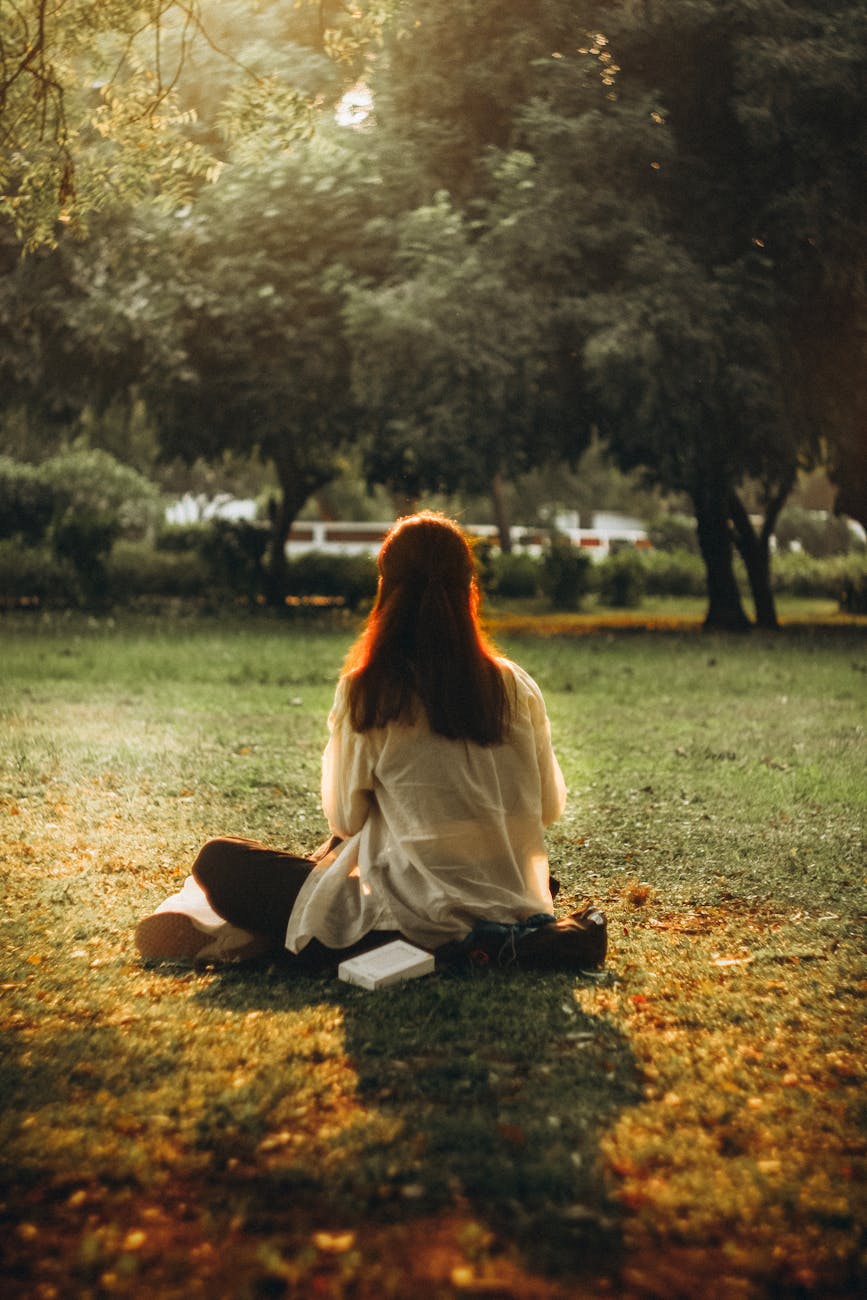 serene woman relaxing in sunlit park