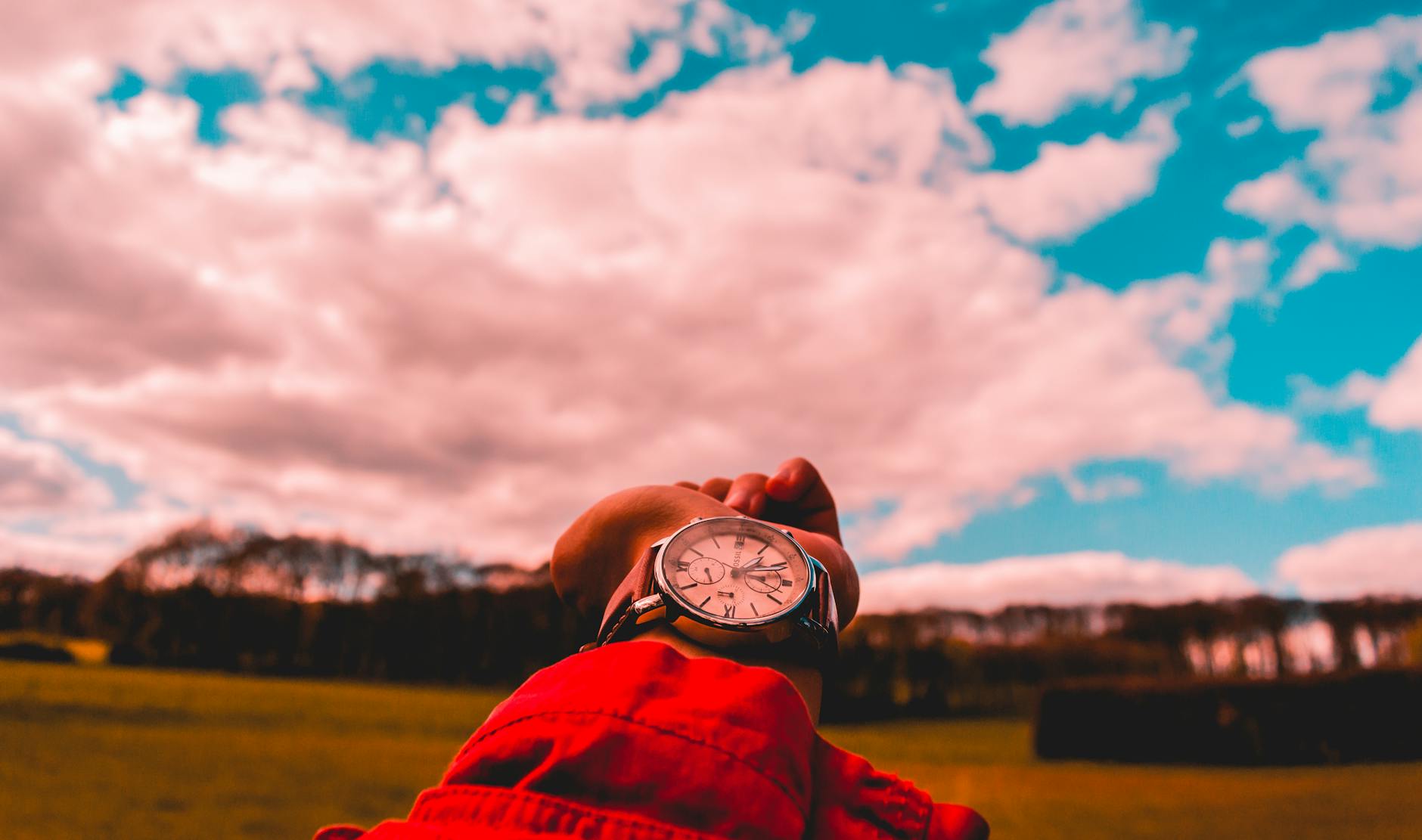 person in red shirt wearing watch
